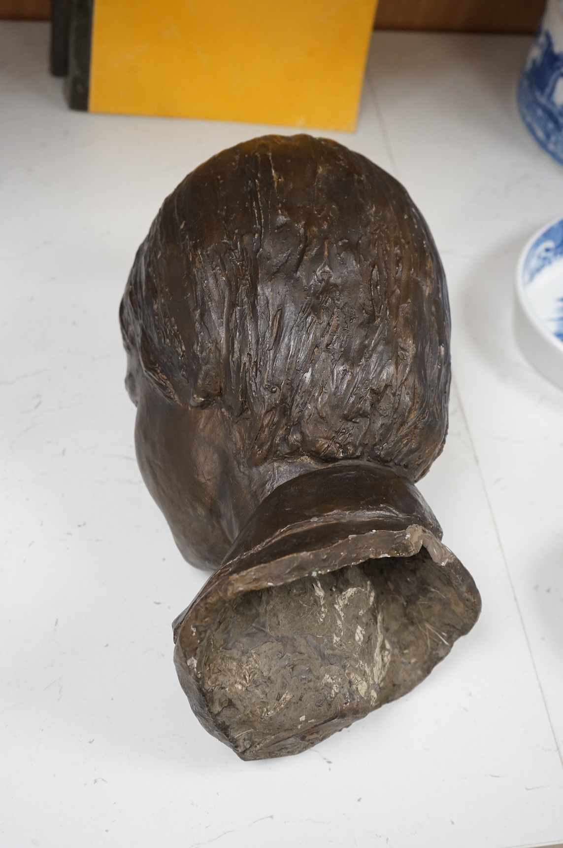 A bronzed head of a child, unsigned, 33cm high